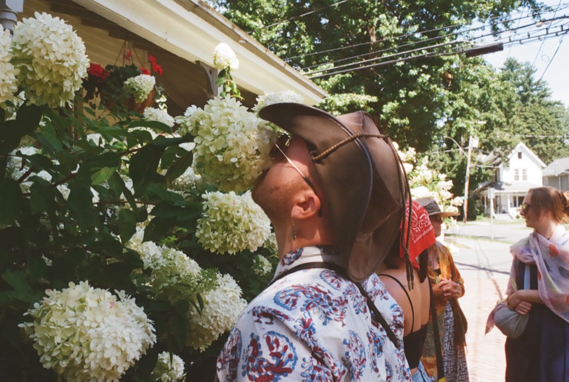 Nico smelling hydrangeas, candid photo with film grain